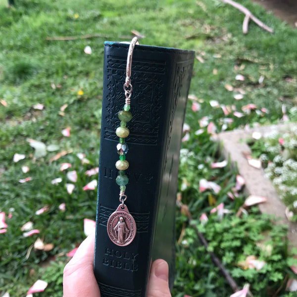 Green Miraculous Medal bookmark in Bible